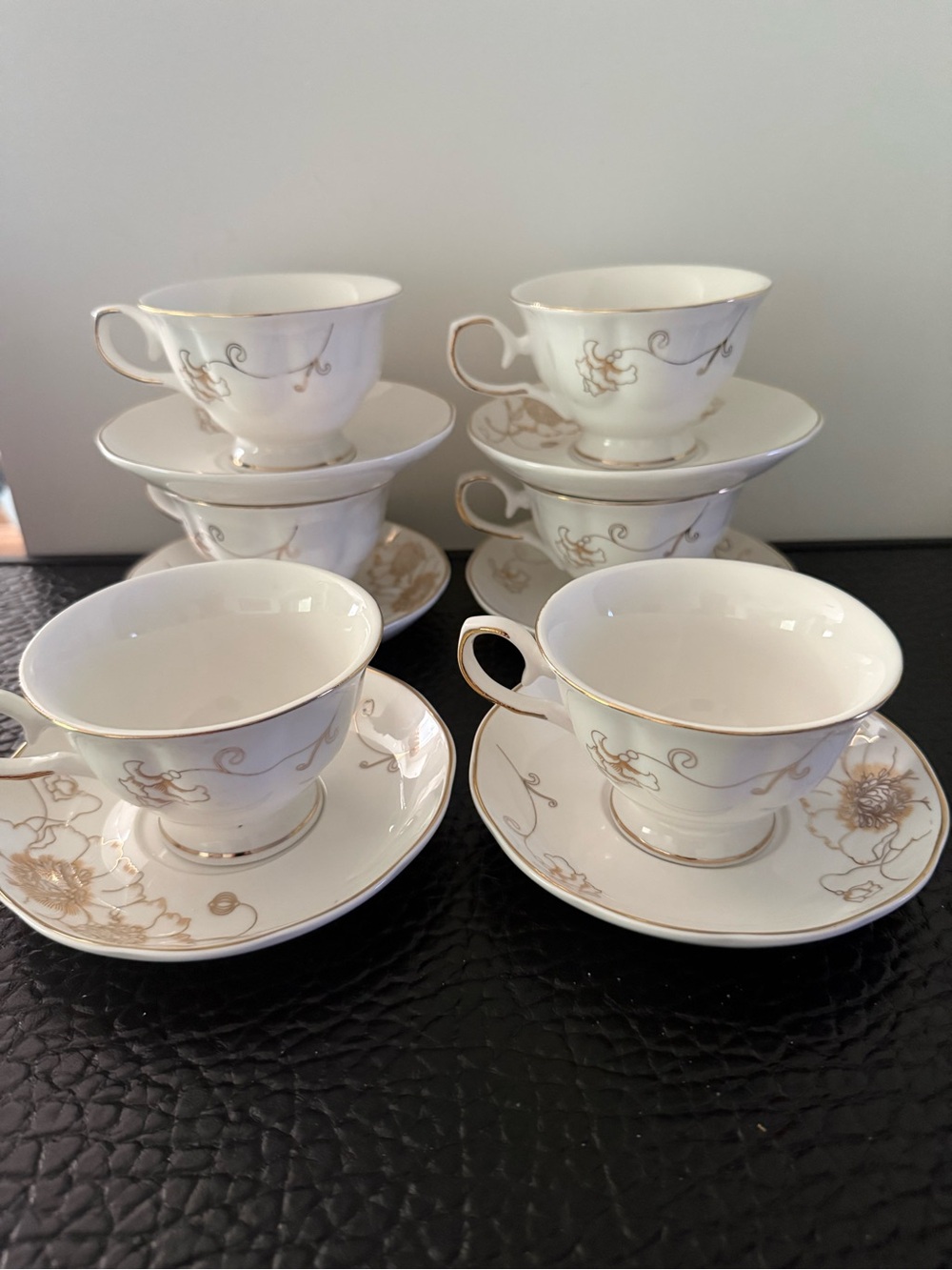 Set Of 6 cup and saucer feature the gold overglaze monogram White porcelain body